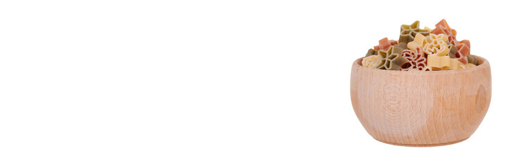 Colored fresh and raw pasta in wooden bowl. Isolated on white background.