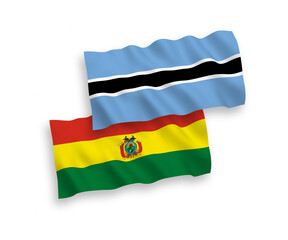 National vector fabric wave flags of Bolivia and Botswana isolated on white background. 1 to 2 proportion.