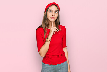 Young brunette woman wearing casual clothes thinking concentrated about doubt with finger on chin and looking up wondering