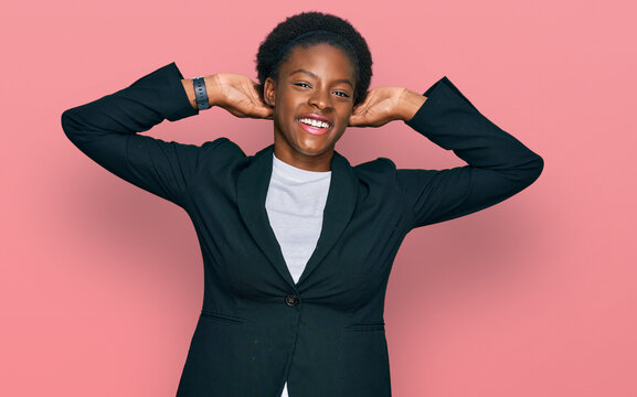 Young african american girl wearing business clothes relaxing and stretching, arms and hands behind head and neck smiling happy