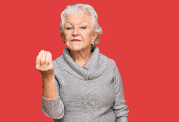 Senior grey-haired woman wearing casual winter sweater doing italian gesture with hand and fingers confident expression