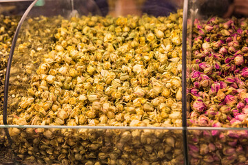 Closeup of different natural dry herbal roses tea in the special box on the street market