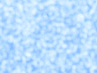 Blue and white bokeh snow background. Concept of Christmas, New Year, Winter and all celebrations. Blurred photo.