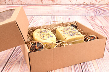 Homemade cosmetics packed in a gift box. The box also contains dried orange slices to add flavor.