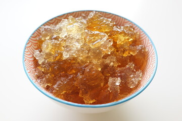 A bowl of soaked Peach Gum. Peach gum is a resin secreted from the bark of the Rosaceae plant peach or mountain peach. High angle view