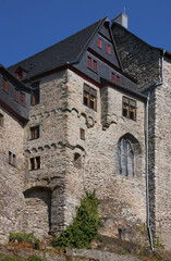 Fototapeta na wymiar Medieval castle with gothic chapel window and renaissance facade on top of the old town of Limburg in Germany, Europe