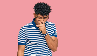 Fototapeta na wymiar Young arab man wearing casual clothes and glasses feeling unwell and coughing as symptom for cold or bronchitis. health care concept.