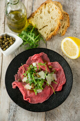 beef carpaccio with arugula capers and parmesan cheese