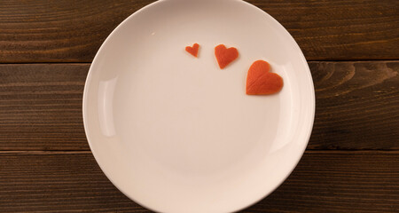 heart made of tangerine peel. postcard, note on a wooden background. gift in a red box