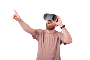 Naklejka premium Young bearded man pointing away and wearing VR glasses, Virtual reality experience