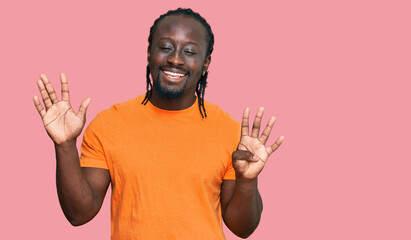 Handsome young african american man wearing casual clothes showing and pointing up with fingers...