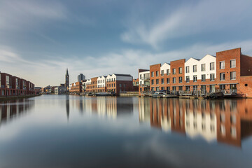 Fototapeta na wymiar Vlaardingen, The Netherlands, February 2020: view of the Buizengat, residential buildings on the waterfront, cityscape