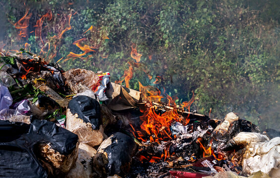 fire burn garbage waste plastic, smoke polluted of waste plastic incineration, garbage waste disposal with burnt incinerate, fire flame garbage burning and smoke air pollution
