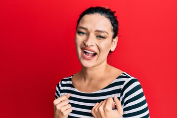 Young caucasian woman wearing casual clothes celebrating surprised and amazed for success with arms raised and eyes closed