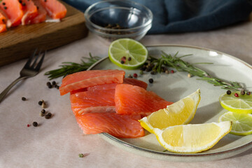 A piece of red trout fish on a chopping board with pepper and lemon is a great nutritious and healthy dish for a healthy lunch or dinner.
