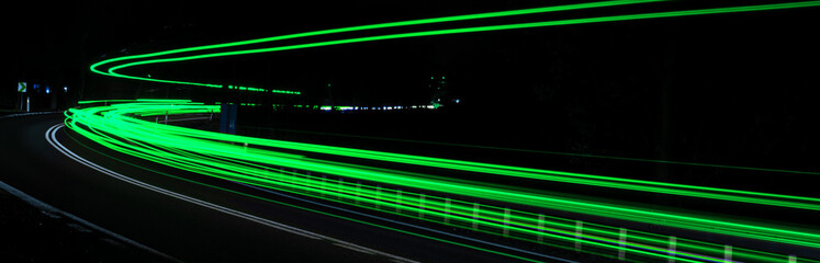 green car lights at night. long exposure