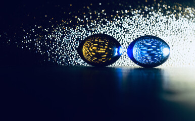 colourful marbles on dark surface