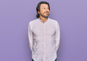 Middle age handsome man wearing business shirt smiling looking to the side and staring away thinking.