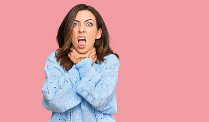 Fototapeta premium Young brunette woman wearing casual winter sweater shouting suffocate because painful strangle. health problem. asphyxiate and suicide concept.