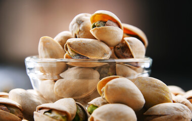 Composition with bowl of in shell pistachios. Delicacies