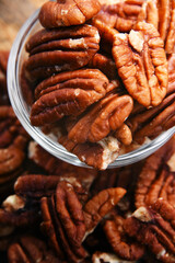 Composition with a bowl of shelled pecan nuts. Delicacies