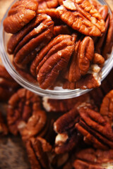 Composition with a bowl of shelled pecan nuts. Delicacies