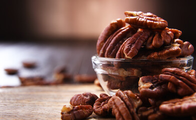 Composition with a bowl of shelled pecan nuts. Delicacies