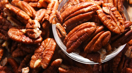 Composition with a bowl of shelled pecan nuts. Delicacies