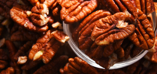 Composition with a bowl of shelled pecan nuts. Delicacies