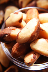 Composition with a bowl of shelled brazil nuts. Delicacies