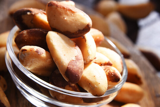Composition with a bowl of shelled brazil nuts. Delicacies