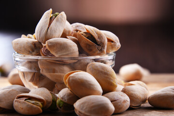Composition with bowl of in shell pistachios. Delicacies