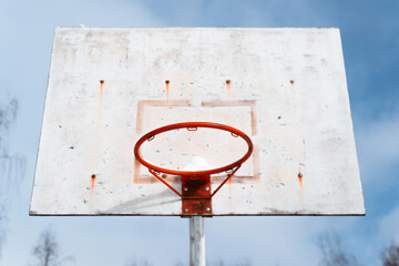 Broken basketball hoop in a disadvantaged area, close-up. Ghetto concept