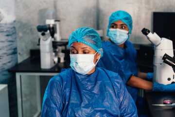 Fototapeta na wymiar Laboratory: Tired doctor staring blankly into the laboratory
