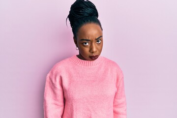 Young african american woman wearing casual winter sweater depressed and worry for distress, crying angry and afraid. sad expression.