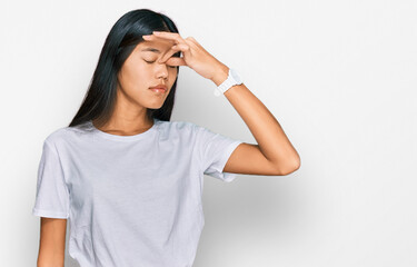 Fototapeta premium Beautiful young asian woman wearing casual white t shirt tired rubbing nose and eyes feeling fatigue and headache. stress and frustration concept.