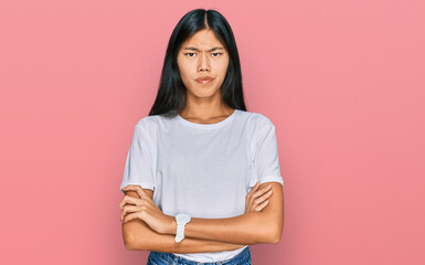 Obraz premium Beautiful young asian woman wearing casual white t shirt skeptic and nervous, disapproving expression on face with crossed arms. negative person.