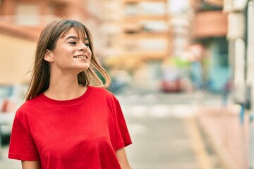 Caucasian teenager girl smiling happy standing at the city.