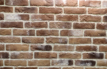 Wall with brickwork under the old destroyed brick of light beige. White mortar, texture, close-up.
