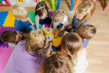 Educational group activity at the kindergarten or daycare - obrazy, fototapety, plakaty
