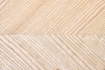 Wooden panel of ash veneer with stylish herringbone texture as background extreme close view from above