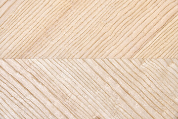 Wooden panel of ash veneer with stylish herringbone texture as background extreme close view from...
