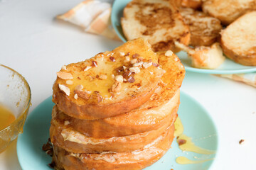 homemade French toast fried with honey and nuts on a blue plate on a dark background. soaked in milk egg mixture. healthy breakfast. close-up