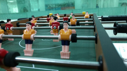 foosball table football game with red and yellow players