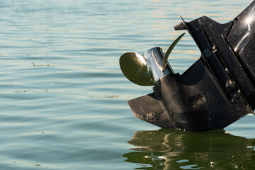 Outboard motor tilted out of the water - obrazy, fototapety, plakaty