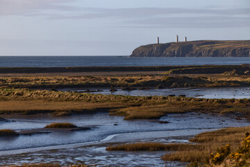 Water lagoon with Irish monument on a cliff. Tramore nature reserve. Waterford. Ireland.