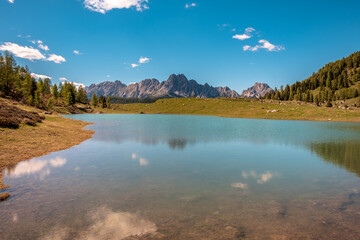 Obraz premium Calm lake in a sunny day in the beautiful Carnic Alps, Friuli-Venezia Giulia, Italy