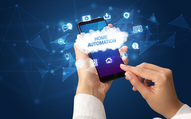 Female hand holding smartphone with HOME AUTOMATION inscription, cloud technology concept