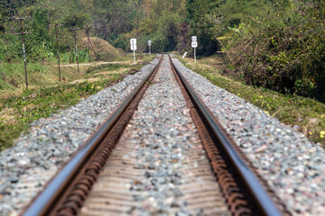 Railway station against beautiful to the forrest with signs. Industrial landscape with railroad with trees in rural area. Transportation concept background.