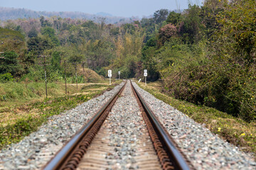 Obraz premium Railway station against beautiful to the forrest with signs. Industrial landscape with railroad with trees in rural area. Transportation concept background.